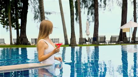 Happy Young Woman Having Fun In Swimming Pool Drinking Non Alcoholic