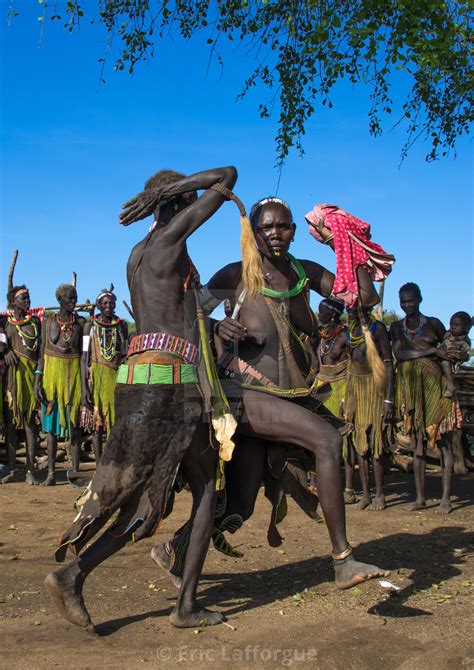 Toposa Tribe Women In Traditional Clothing Dancing During A Ceremony