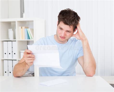 Confused Man Looking At Paper Stock Photo Image Of Expression Adult