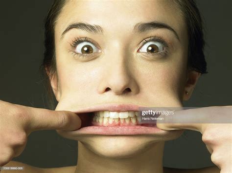 Young Woman Stretching Lips Pulling Funny Face Closeup Portrait Photo