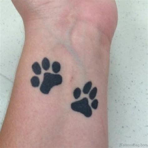 Black dog in paw print tattoo design. 35 Pretty Paw Print Tattoos For Wrist