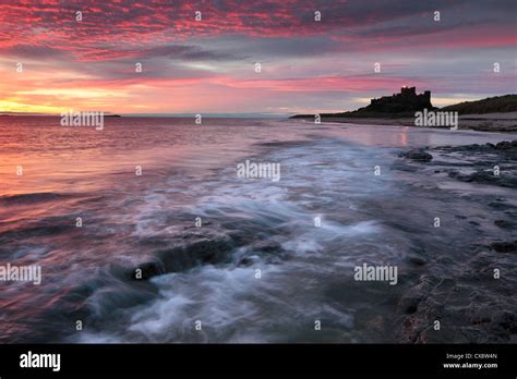 Sunrise Over Bamburgh Castle On The Northumberland Coast Stock Photo