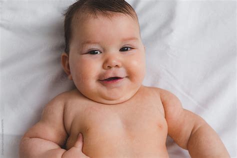 Chubby Infant Baby Nude On Bed Sheet By Giorgio Magini