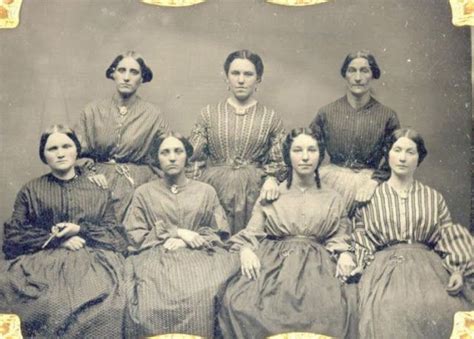 An Old Photo Of Women In Dresses Sitting Next To Each Other