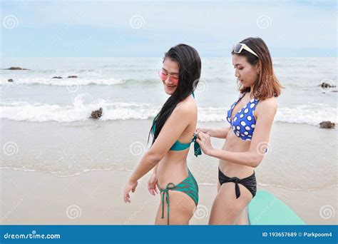 Two Beauty And Asian Lesbian Women In Green And Blue Bikini Who