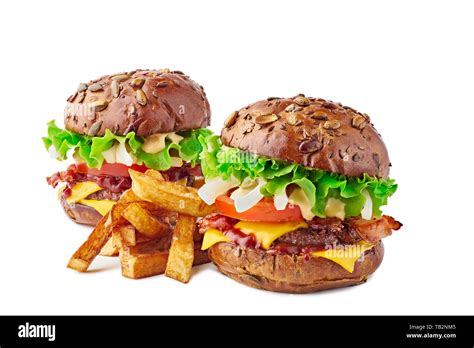 Two Hamburgers With Cereal Buns And French Fries On White Stock Photo