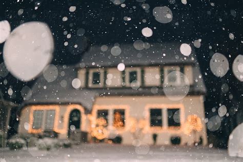 Snow Falling Outside Of A Suburban Home At Christmas Del Colaborador
