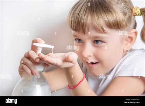 Girl Squirts Liquid Soap Into Hands Stock Photo Alamy
