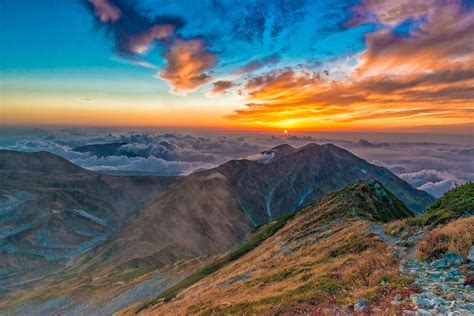 Scenic View Of Mountains Against Dramatic Sky At Sunset · Free Stock Photo