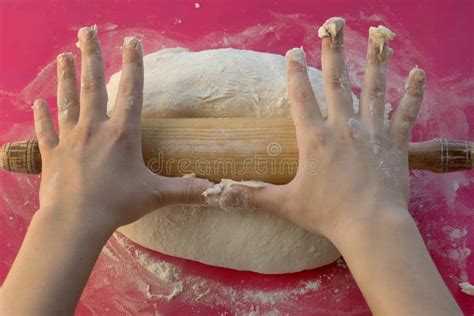 Children S Hands Roll Out The Dough With A Wooden Rolling Pin Flour Is