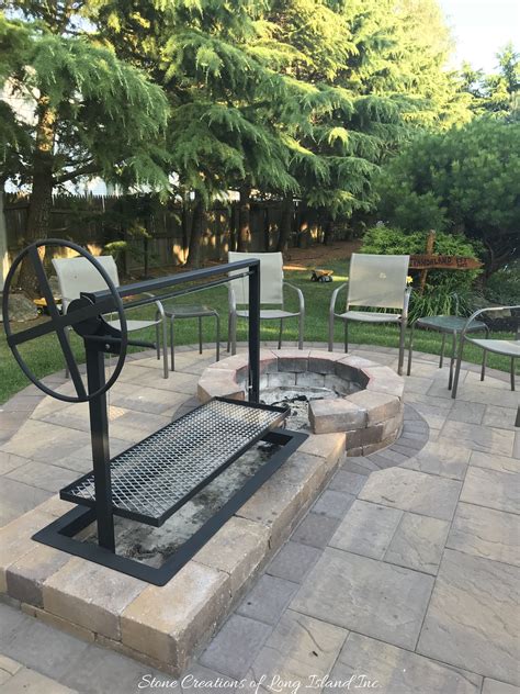 Outdoor kitchen with wood burning oven. Argentinian Parilla Grill built with Cambridge Pavers for ...