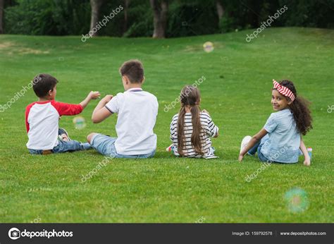 Multiethnic Children Playing In Park — Stock Photo © Alebloshka 159792578