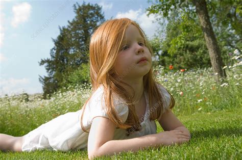 Girl Laying On Grass In Field Of Flowers Stock Image F0042300
