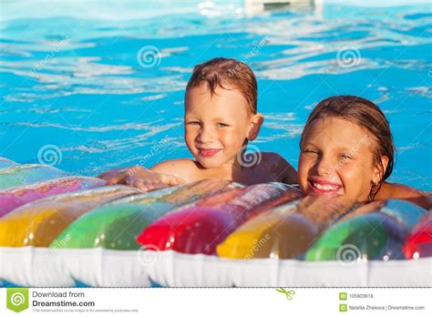 Little Children Playing And Having Fun In Swimming Pool With Air Stock