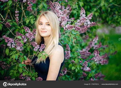 Portrait Of A Young Woman Blonde Glasses Outdoors In The Park Stock