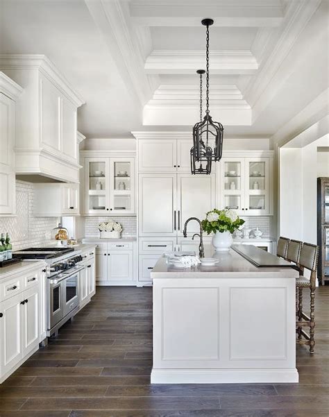 In fact, they can have an upscale, contemporary feel when designed correctly. White Raised Panel Kitchen Cabinets with White Mini Subway ...