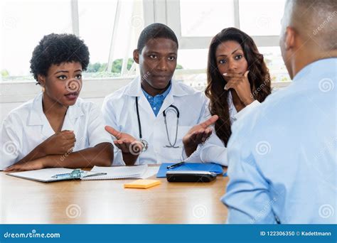 Group Of African American Doctors With Patient Stock Photo Image Of