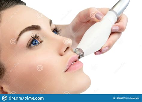 Therapist Beautician Makes A Rejuvenating Facial Massage For The Model By Lpg Apparatus In A