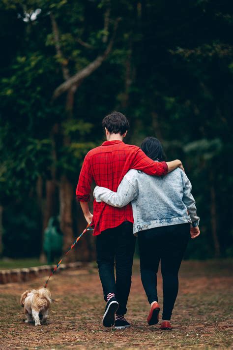 Download Romantic Couple Walking A Dog Wallpaper | Wallpapers.com