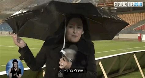 12 People Struggling Comically With Umbrellas In The Wind