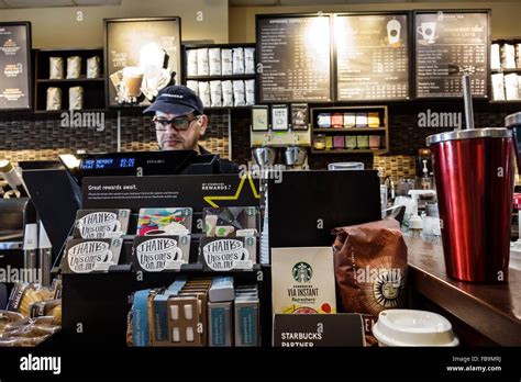 Miami Florida,Starbucks Coffee,cafe,interior inside,adult adults man