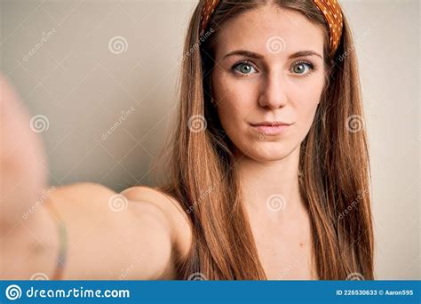 Young Beautiful Redhead Woman Wearing Diadem Make Selfie By The Camera With A Confident