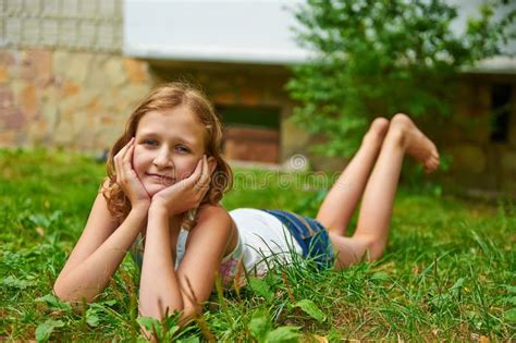 Twelve Year Old Girl Lies On The Grass And Smiling Stock Photo Image