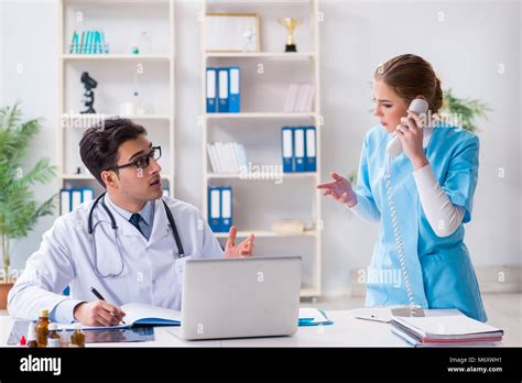 Male And Female Doctor Having Discussion In Hospital Stock Photo Alamy