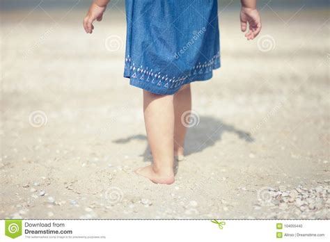 Cute Little Girl At The Beach Of The Ocean Stock Photo