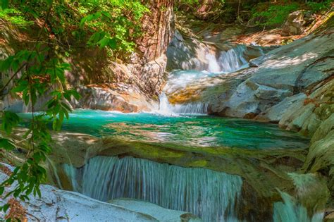 Photo Of River Flowing In Between Rock And Trees Waterfall Nature