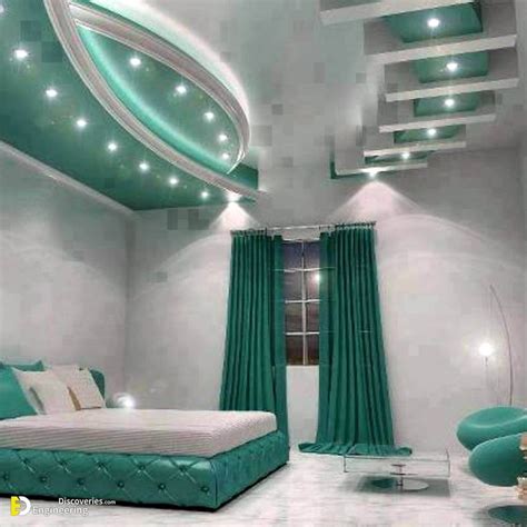 A Bedroom With White Walls And Green Curtains On The Ceiling Along