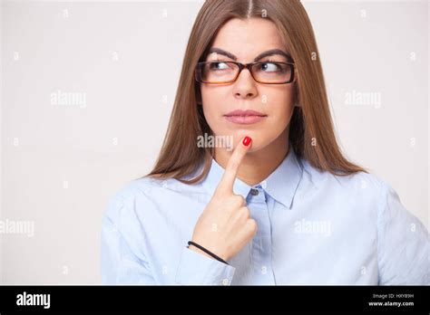 Young Beautiful Business Woman Thinking While Standing Against Gray