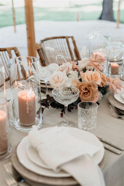 The Table Is Set With Candles Plates And Napkins For An Elegant