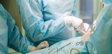 Surgical Team Performing Cosmetic Surgery In Hospital Operating Room Surgeon Working On A