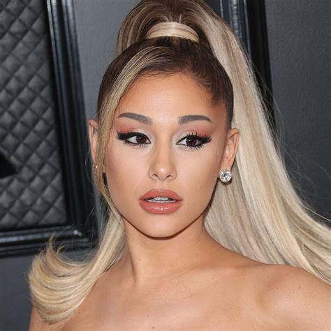 ariana grande shows off her legs on instagram in sheer tights and a black micro mini