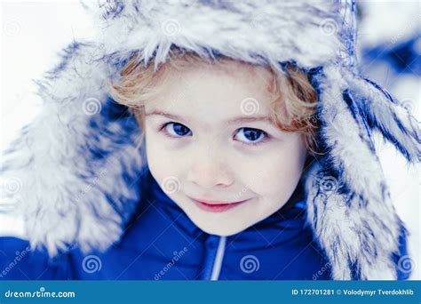 Winter Child Face Close Up Happy Child Playing With Snow On A Snowy