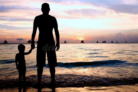 Padre E Hijo En El Mar De La Puesta Del Sol Foto De Archivo Imagen De