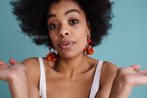 Confused Young African Woman Shrugging Shoulders Stock Photo By