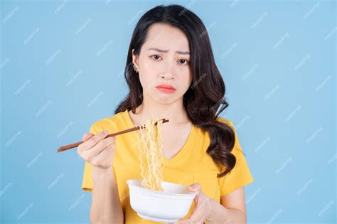 Premium Photo Image Of Young Asian Woman Eating Instant Noodles