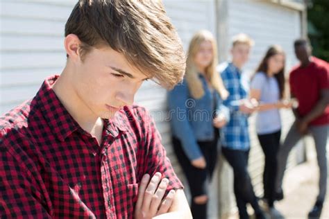 Unhappy Teenage Boy Being Gossiped About By Peers Stock Image Image