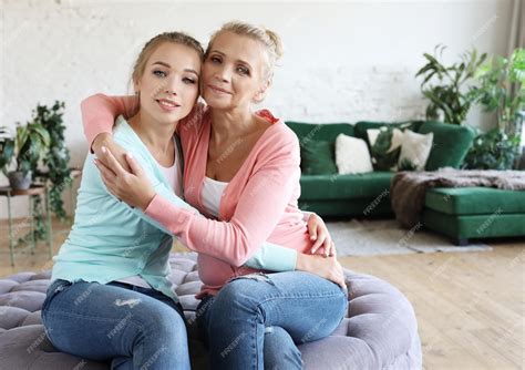Premium Photo Beautiful Senior Mom And Her Adult Daughter Are Hugging Looking At Camera And