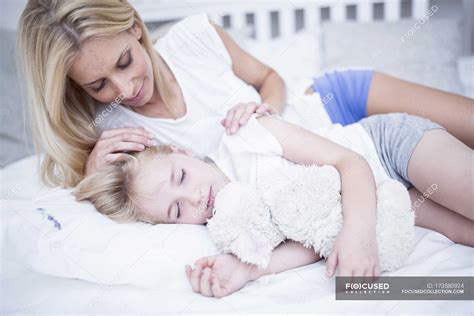 Mother Looking At Sleeping Daughter In Bed — Watching Relaxed Stock