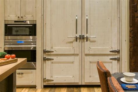 When the cabinet door is touched just over the latch, a spring pops the door open enough so the lip can be grabbed and the door pulled open. Kitchen Cabinets With Antique Latches | HGTV