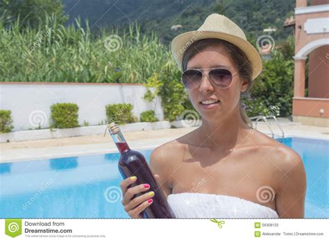 Young Brunette Girl In Bikini Holding Bottle Of Wine Stock Image