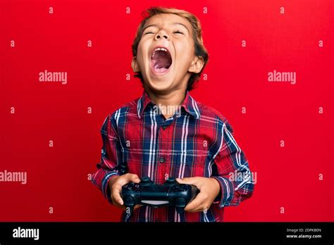 Adorable Latin Kid Playing Video Game Holding Controller Angry And Mad