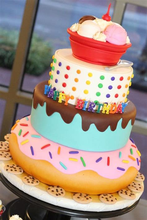 Three Tiered Cake With Frosting Sprinkles And Ice Cream On Top