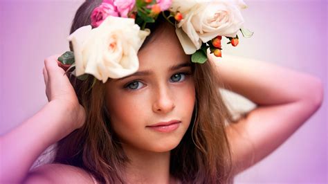Cute Girl Is Having Flowers Crown On Head Facing One Side
