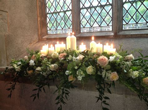 Windowsill Dressed With Candles And Cascading Flowers