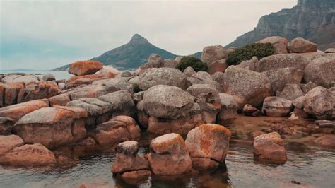 Boulders Of Rock Lying Along Coastline Of The Sea In Cape Town South