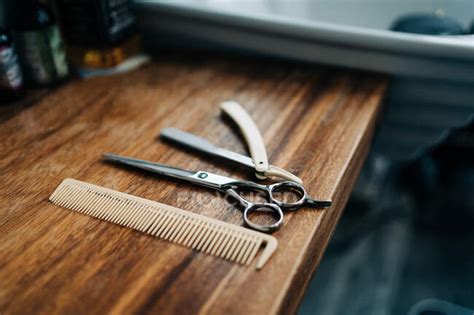 From Above Scissor And Comb Near Straight Razor With Sharp Metal Blades